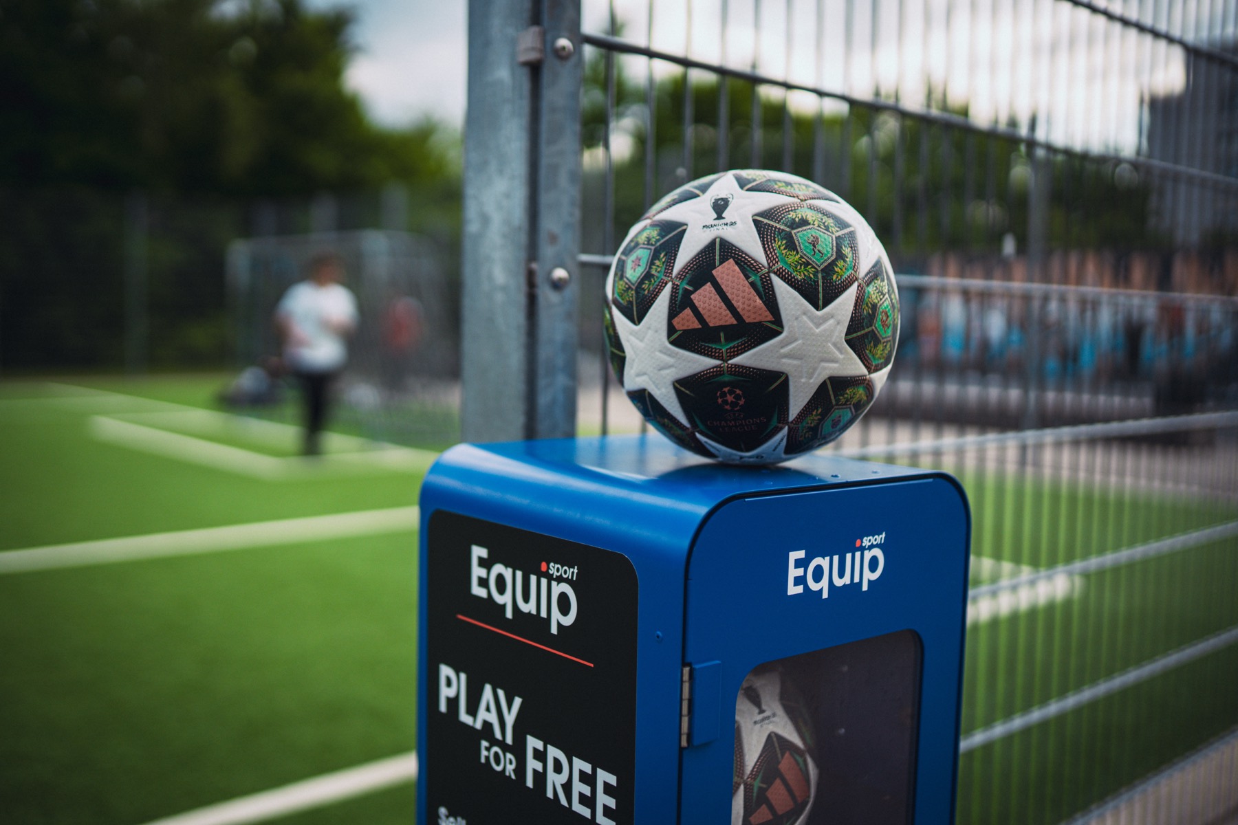 The adidas Champions League knockout ball resting on top of a blue Equip Sport station marked Play for free.