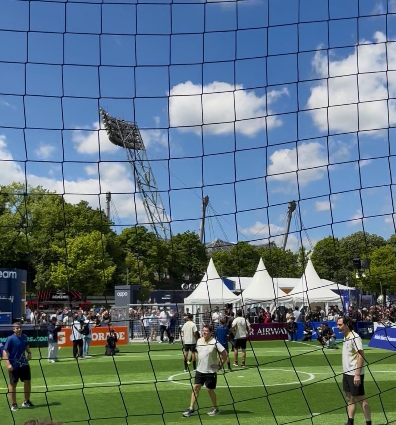 A 5v5 festival pitch seen through the net.